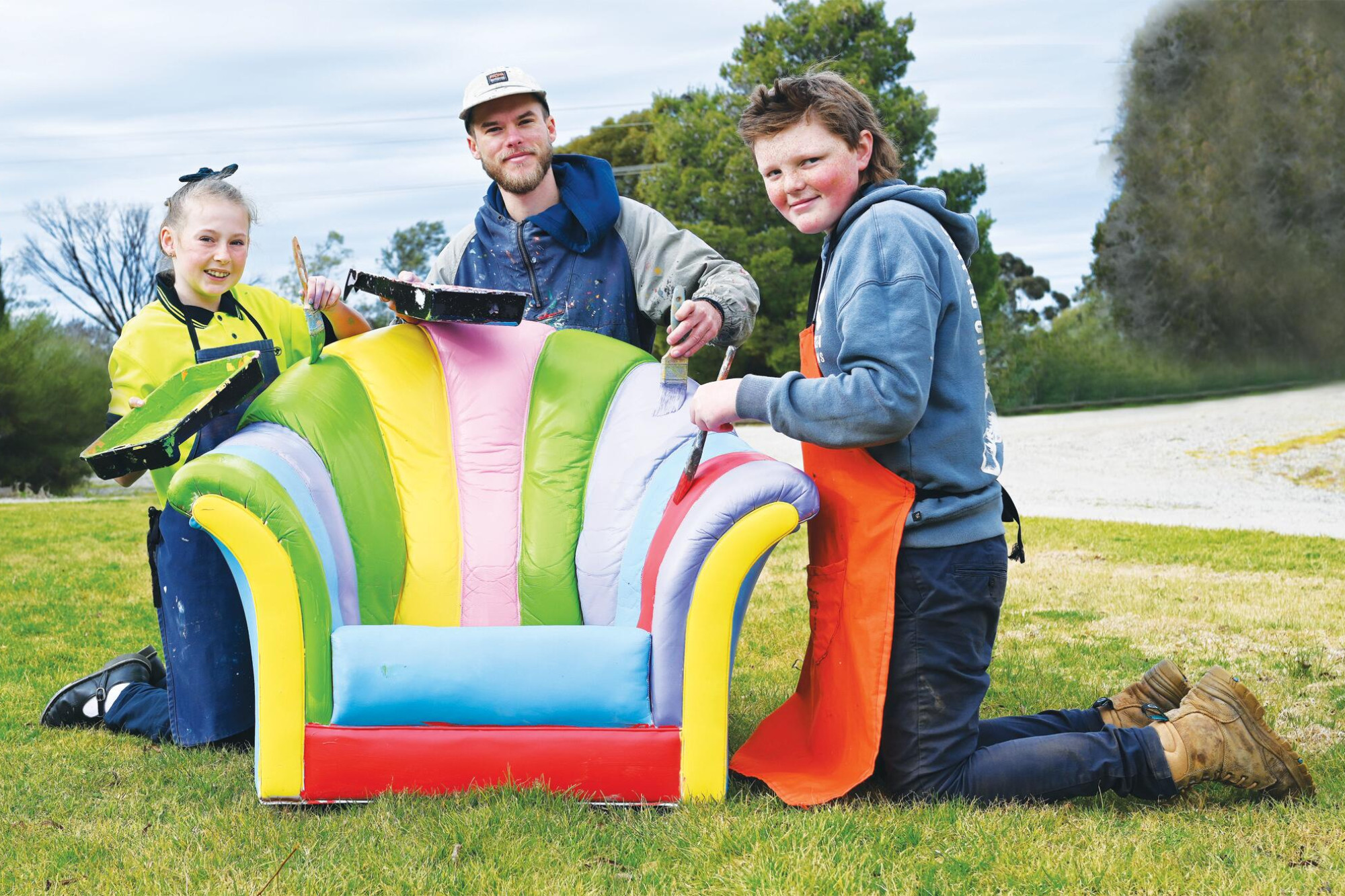 Jamison Walters, Lukas Kasper and Toby Peter give a pop-up art sofa the finishing touches. LH PHOTO