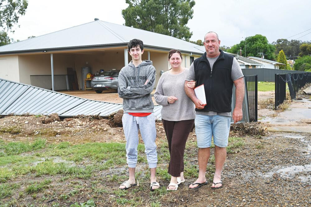 Danny, Ros and Laurie Witham outside their Chapel Street home after the Christmas Day floods.. LH PHOTO