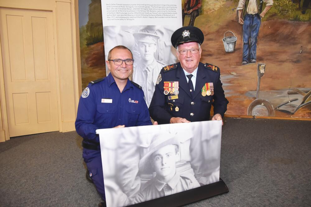 Tarnagulla Fire Brigade captain George Filev and Barry Condick prepare banners for display on ANZAC Day. LH PHOTO LH PHOTO
