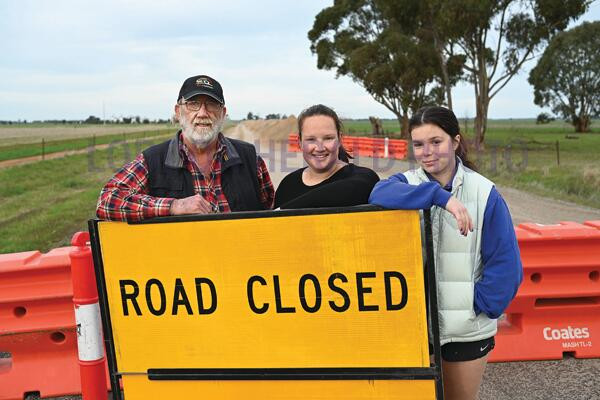 Alan Wiltshire with Emily and Ingrid Hocking in front of piles of soil ripped up as a second attempt is made to repair Prairie-Rochester Road. LH PHOTO