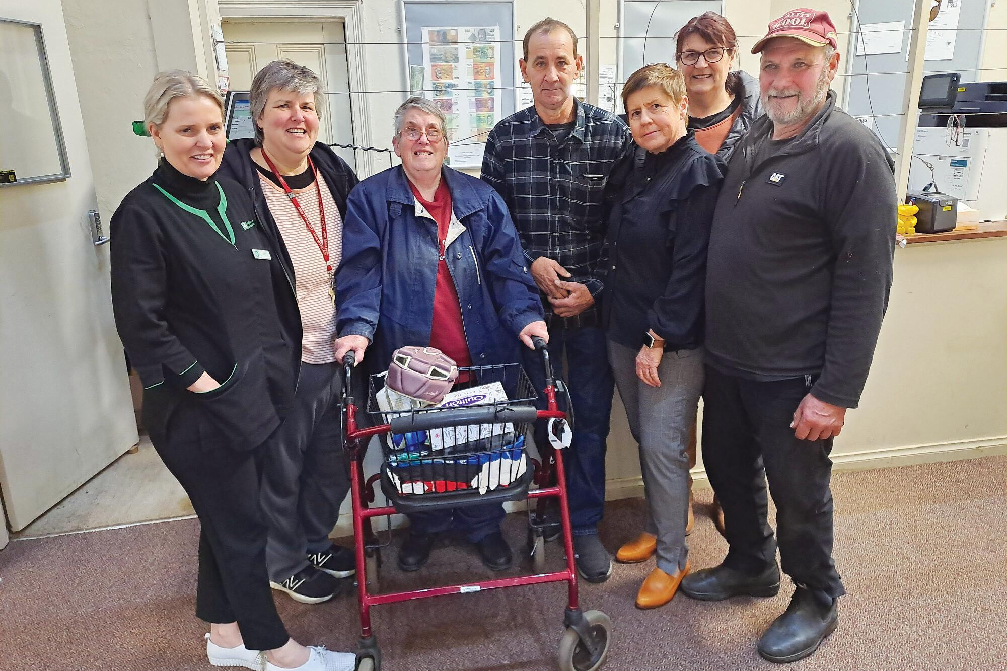 Rebecca Grogan, Raeleen Fletcher, Rhonda Dutton, Mark Lacey, Colleen Hampson, Fiona Moon and Geoff Hampson gather to mark the final minutes of Pyramid Hill’s bank agency. LH PHOTO