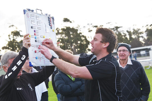 Boort coach Dale Cameron sets strategy for the final term. LH photo