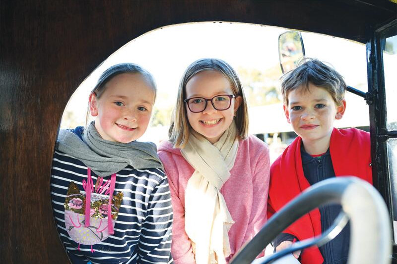 Stephanie, Charlotte and Michael Bogwitz check out the vintage vehicles. LH PHOTO