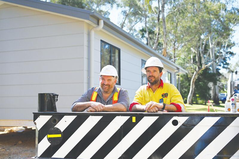 Two in place, two to go ... Daniel Starkie and Daniel Penna midway through Friday’s arrival of new cabins at Wedderburn Caravan Park. LH PHOTO