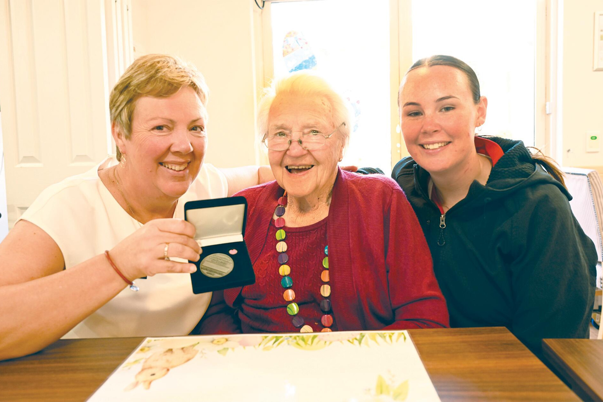 Shirley Heather (centre) is congratulated by daughter Ruth Penny and IDHS’s Maddy Foster. LH PHOTO