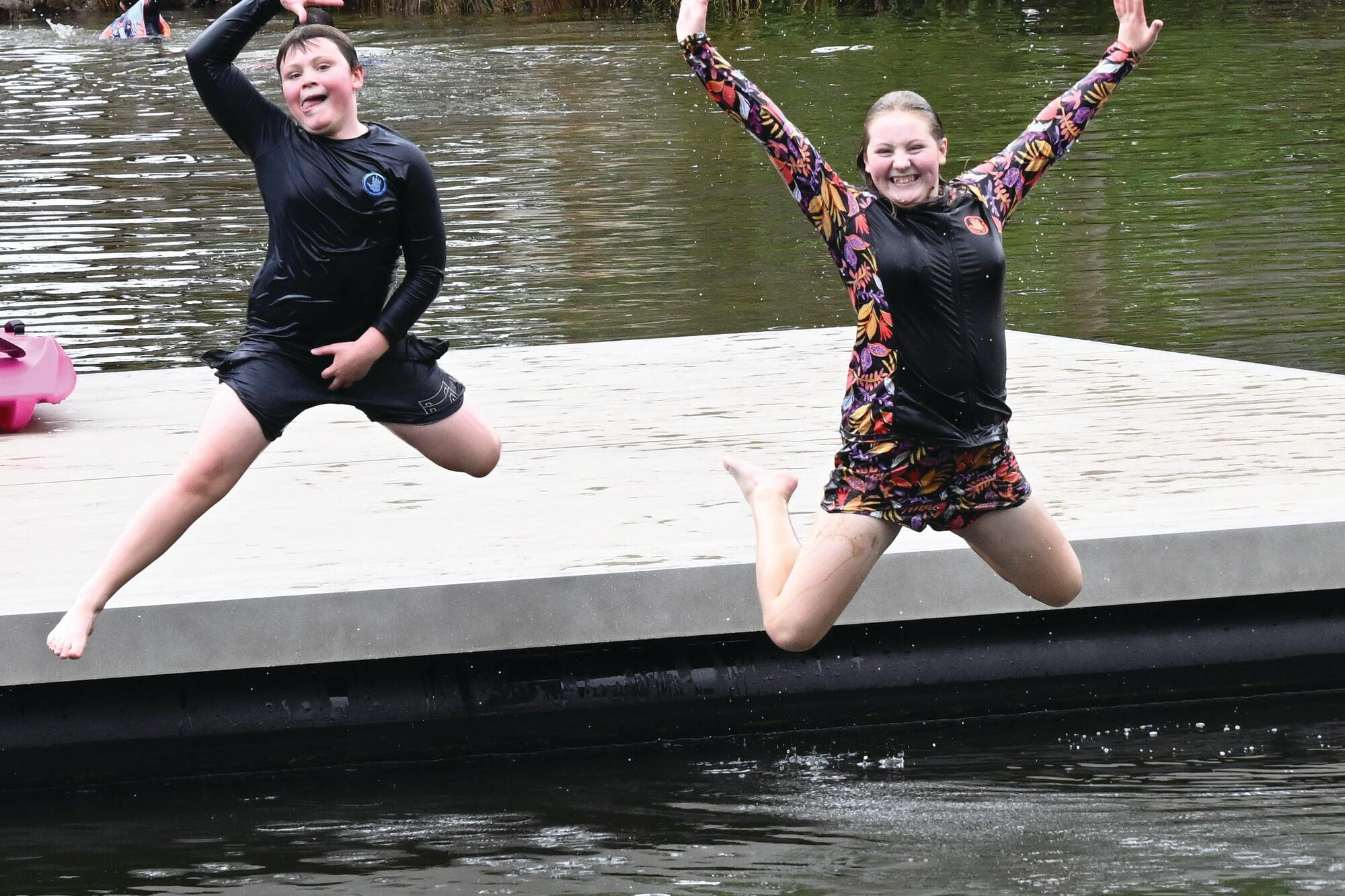 Riley and Bella Frost, of Bendigo, dive off the Bridgewater swimming hole pontoon