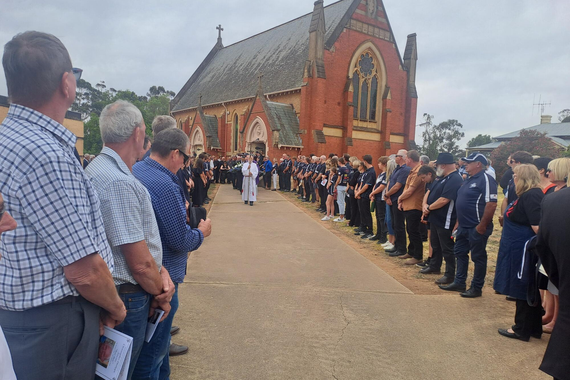 Staff from FP Nevins and Co and Inglewood Football Netball Club form a guard of honour for Chris Nevins. LH PHOTOS