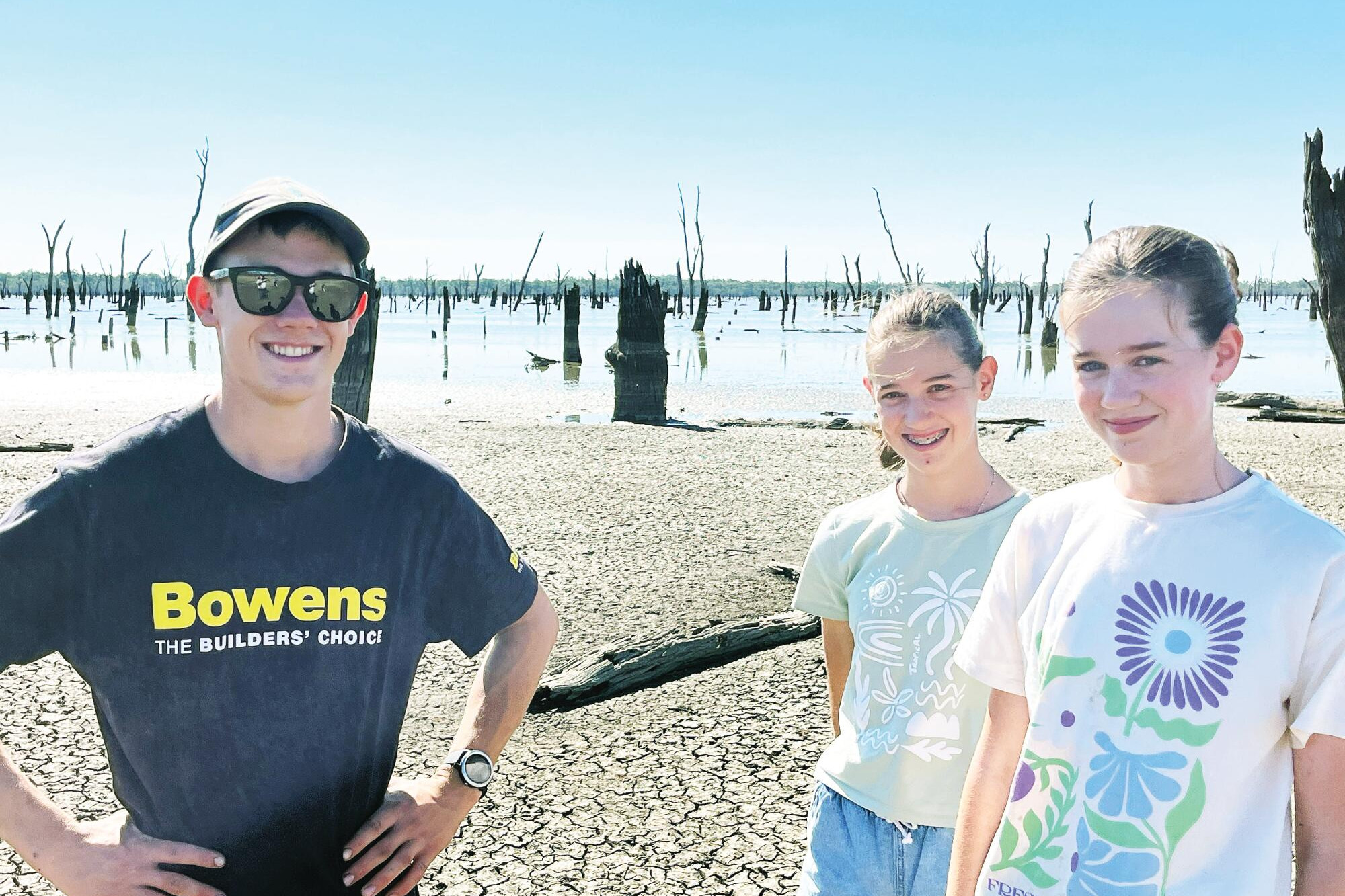 Elijah, Myra and Lydia Keith on the mud-cracked bed of Lake Boort at the weekend