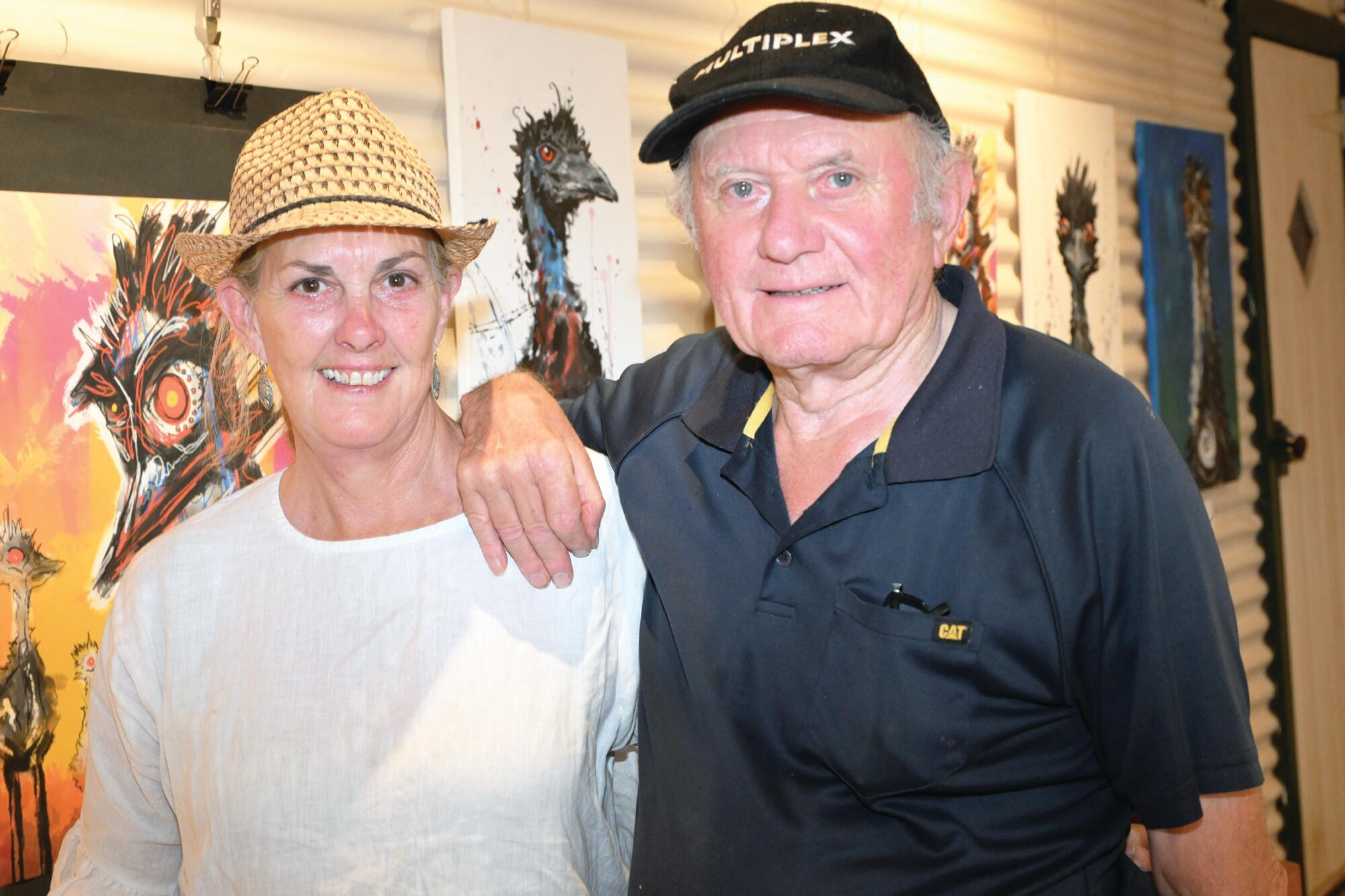 Andrea Pyatt and Bob Nicholls admire Elijah’s emu series on display at the gallery. LH PHOTO