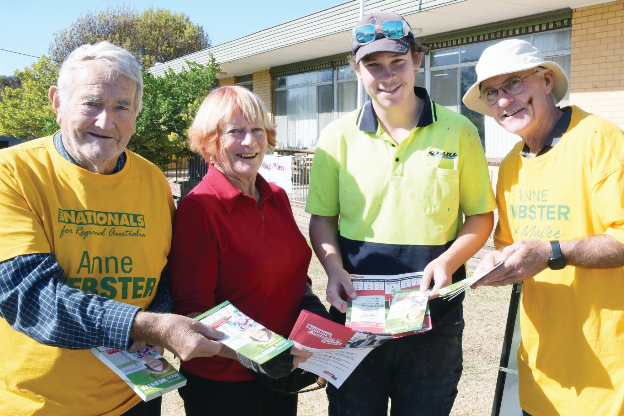 Ken Pattison, Jill Millie and Graham Nesbit hand how-to-vote cards to Jim Van De Wetering (third left) outside the Wedderburn booth. LH PHOTO