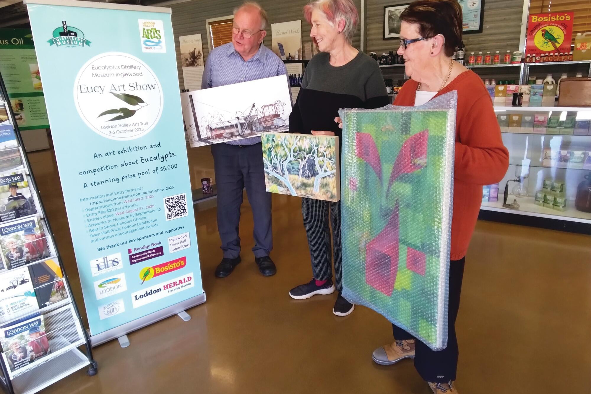 Jeff Hooley, Robyn Holtham and Judy Metcalf with some of the entries that are arriving ready for the exhibition