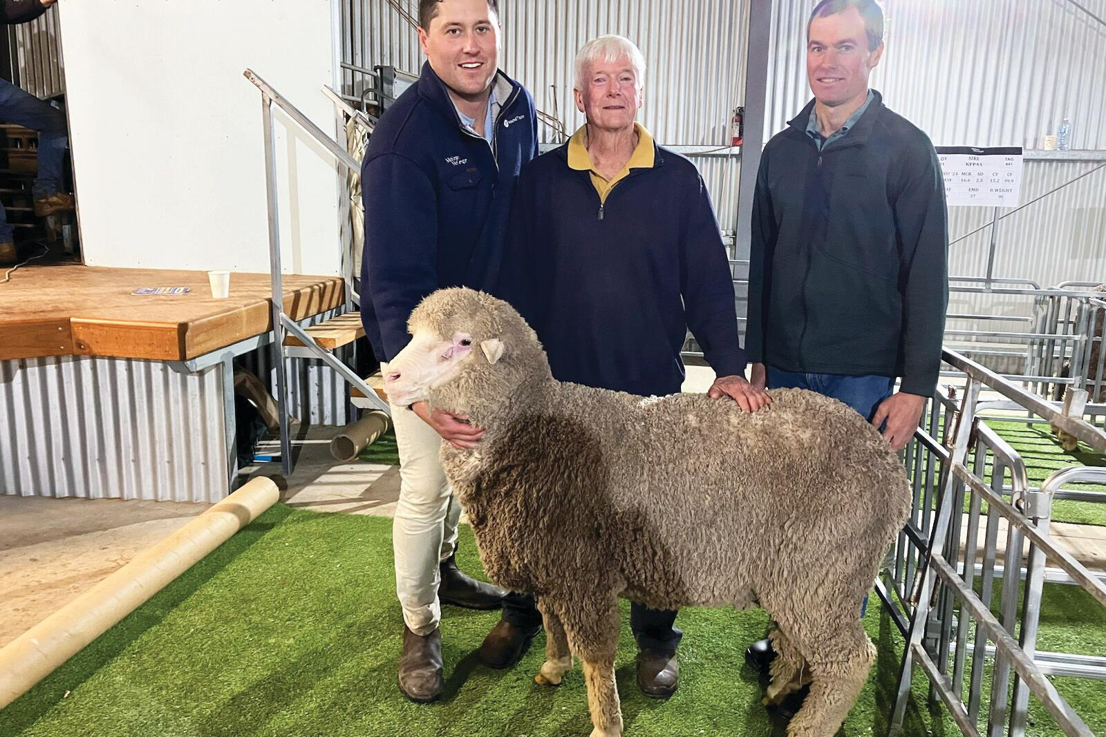 Auctioneer Will Holt, Erroll Hay and Nick Punton with the top priced ram