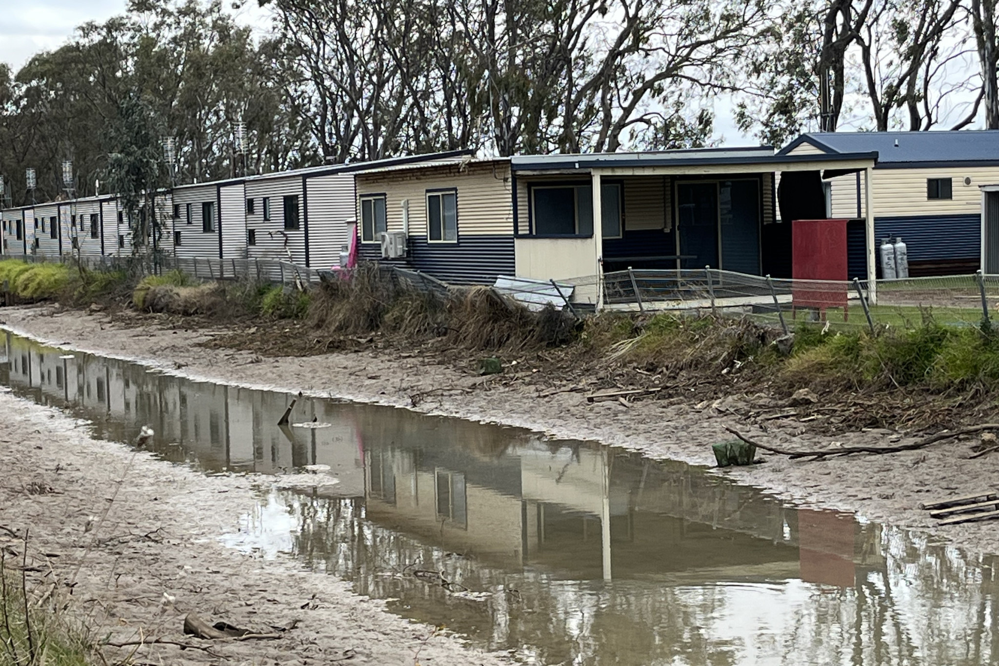Safety fence dangles over channel at Boort caravan park