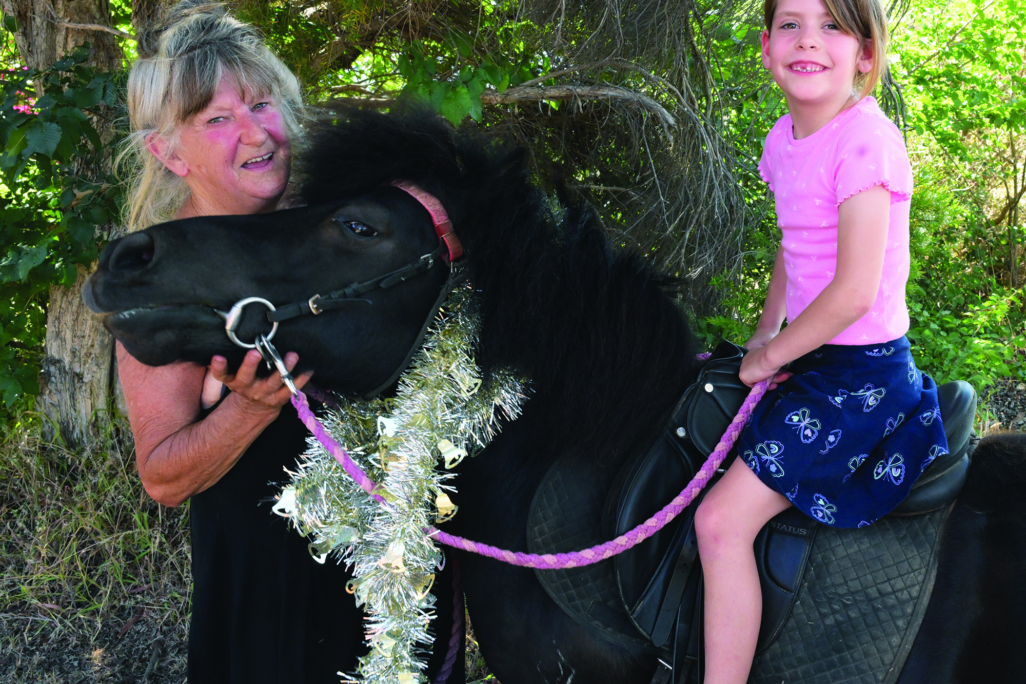 Wendy Muphy steers Helena Wilson for a popular donkey ride at the community celebrations. LH PHOTO